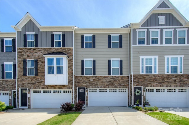 411 Lahinch Dr, Tega Cay, SC 29708 - townhome / multi-family property with board and batten siding, driveway, stone siding, and a garage
