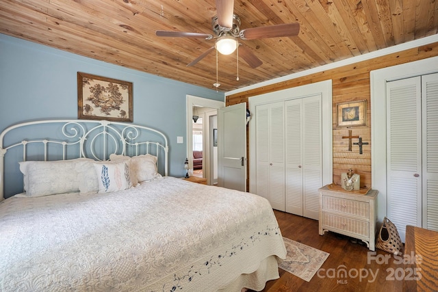 576 Washington Ave NW, Valdese, NC 28690 - bedroom featuring wood ceiling, two closets, wood finished floors, a ceiling fan, and wooden walls