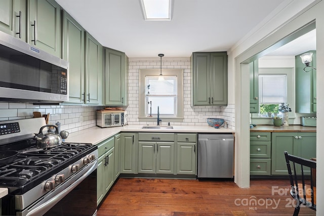 576 Washington Ave NW, Valdese, NC 28690 - kitchen featuring green cabinetry, appliances with stainless steel finishes, light countertops, and backsplash