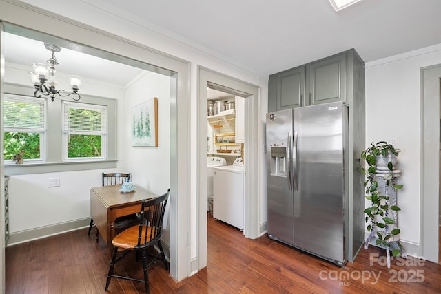 576 Washington Ave NW, Valdese, NC 28690 - dining space with ornamental molding, dark wood finished floors, a chandelier, and washer and dryer