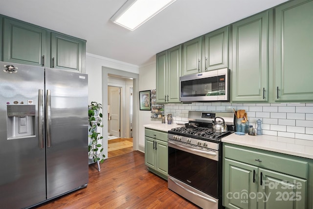576 Washington Ave NW, Valdese, NC 28690 - kitchen with stainless steel appliances, green cabinets, light countertops, tasteful backsplash, and dark wood-type flooring