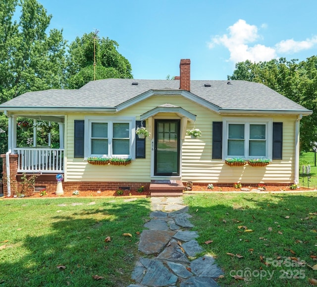 576 Washington Ave NW, Valdese, NC 28690 - view of front of home with a chimney, a front lawn, and roof with shingles