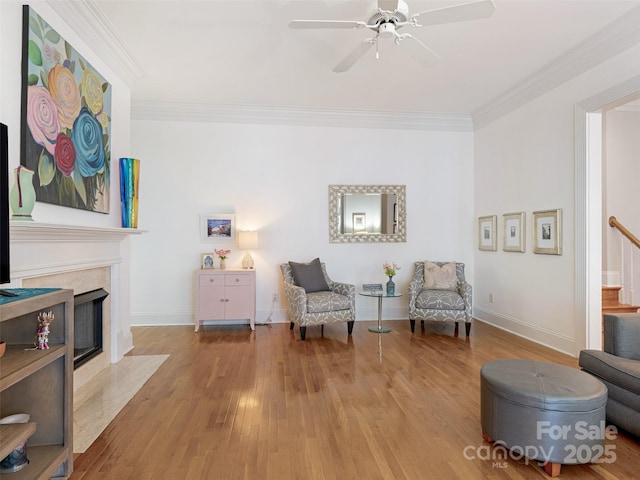 8918 Cotton Press Rd, Charlotte, NC 28277 - living area with ceiling fan, ornamental molding, wood finished floors, a fireplace, and stairway