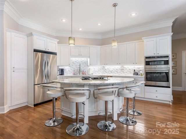 8918 Cotton Press Rd, Charlotte, NC 28277 - kitchen with stainless steel appliances, white cabinetry, a kitchen island, backsplash, and ornamental molding