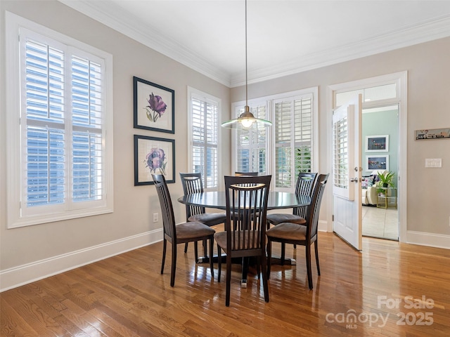 8918 Cotton Press Rd, Charlotte, NC 28277 - dining area featuring healthy amount of natural light, wood finished floors, and ornamental molding