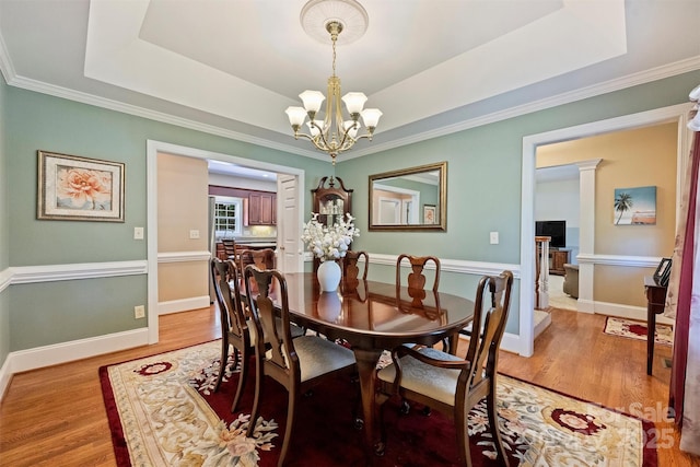 6309 Chamar Cir, Kannapolis, NC 28081 - dining area with a chandelier, light wood-style flooring, ornamental molding, and a tray ceiling
