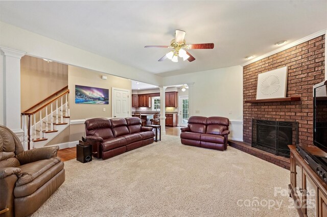 6309 Chamar Cir, Kannapolis, NC 28081 - living room with ornate columns, ceiling fan, a brick fireplace, stairs, and light colored carpet