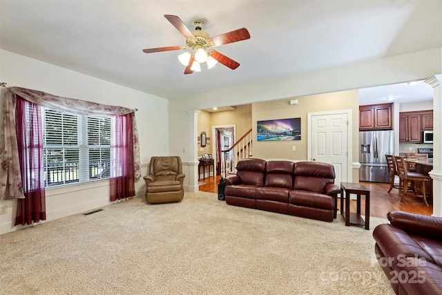 6309 Chamar Cir, Kannapolis, NC 28081 - living area featuring ornate columns, carpet, ceiling fan, and stairway