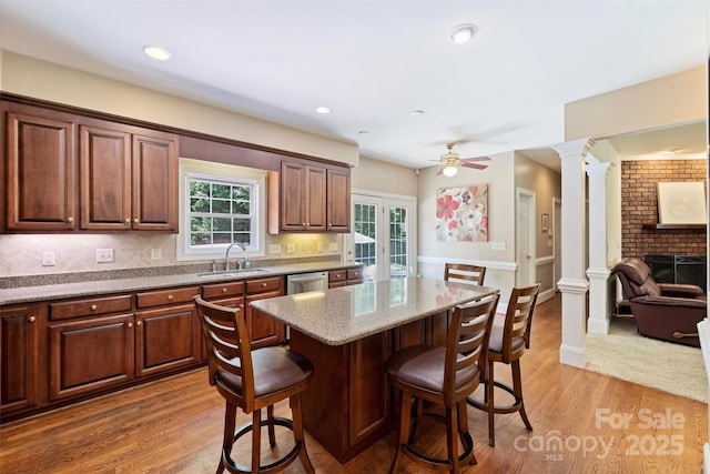 6309 Chamar Cir, Kannapolis, NC 28081 - kitchen featuring ornate columns, a kitchen breakfast bar, dishwasher, a ceiling fan, and tasteful backsplash