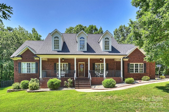6309 Chamar Cir, Kannapolis, NC 28081 - new england style home with covered porch, a front lawn, brick siding, and a ceiling fan