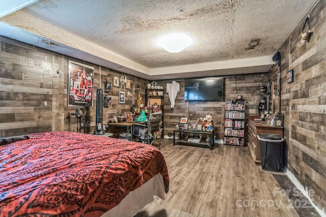 1713 Poe Cir, Hickory, NC 28601 - bedroom featuring wooden walls, a textured ceiling, and wood finished floors