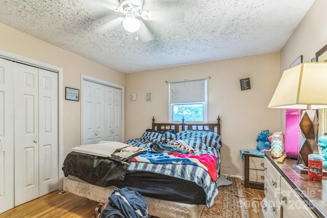 1713 Poe Cir, Hickory, NC 28601 - bedroom featuring multiple closets, light wood-style floors, a textured ceiling, and a ceiling fan