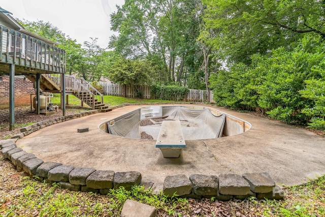 1713 Poe Cir, Hickory, NC 28601 - fenced backyard featuring stairs, a deck, a patio area, and view of scattered trees