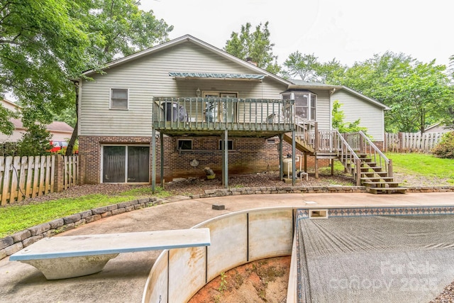 1713 Poe Cir, Hickory, NC 28601 - back of property featuring stairway, a fenced backyard, a wooden deck, and brick siding
