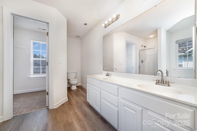 5233 Halverson Ct, Kannapolis, NC 28083 - bathroom featuring wood finished floors, double vanity, and a shower with shower door