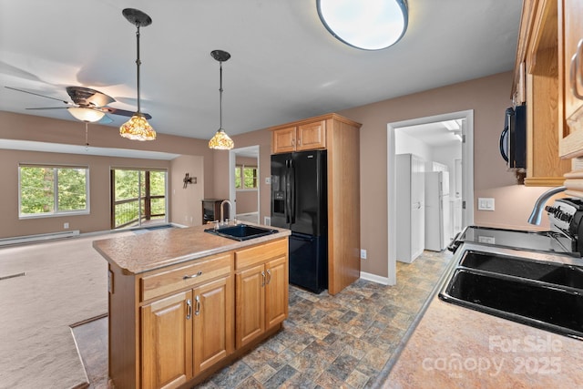 435 Pauline Ave, Franklin, NC 28734 - kitchen with black refrigerator with ice dispenser, a baseboard radiator, ceiling fan, an island with sink, and light countertops