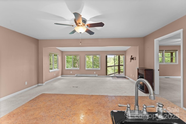 435 Pauline Ave, Franklin, NC 28734 - unfurnished living room with carpet floors, plenty of natural light, a ceiling fan, and baseboard heating