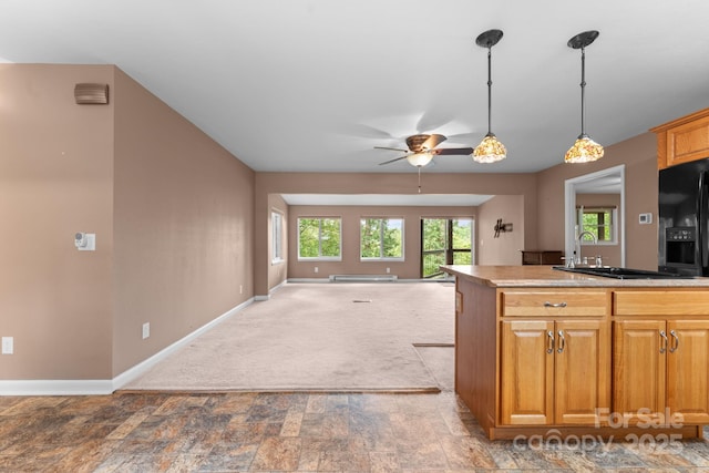 435 Pauline Ave, Franklin, NC 28734 - kitchen with a ceiling fan, black fridge, a baseboard radiator, open floor plan, and decorative light fixtures