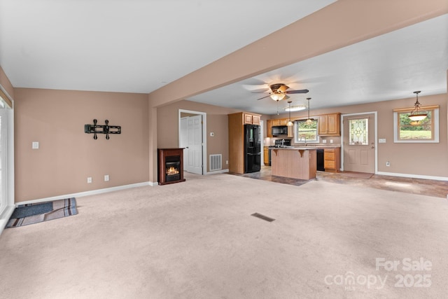 435 Pauline Ave, Franklin, NC 28734 - unfurnished living room with light carpet, a lit fireplace, and ceiling fan