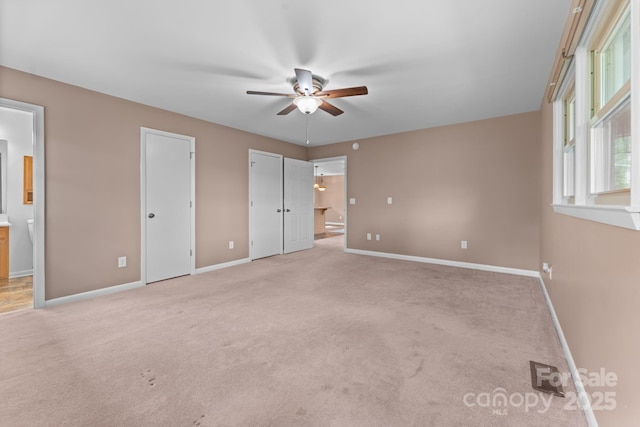 435 Pauline Ave, Franklin, NC 28734 - unfurnished bedroom featuring light colored carpet, multiple closets, ensuite bath, and ceiling fan