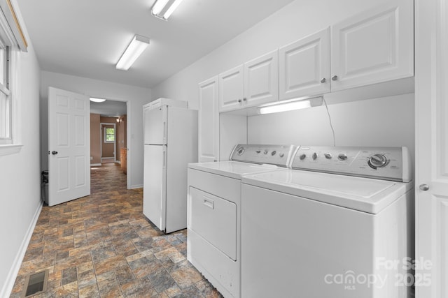 435 Pauline Ave, Franklin, NC 28734 - laundry area featuring washing machine and dryer, stone finish flooring, and cabinet space