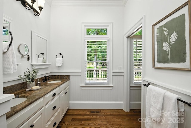 3408 Sandalwood Ln, Waxhaw, NC 28173 - bathroom featuring wood finished floors, double vanity, a wainscoted wall, plenty of natural light, and crown molding
