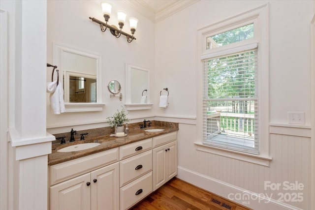3408 Sandalwood Ln, Waxhaw, NC 28173 - bathroom featuring ornamental molding, double vanity, wainscoting, and wood finished floors