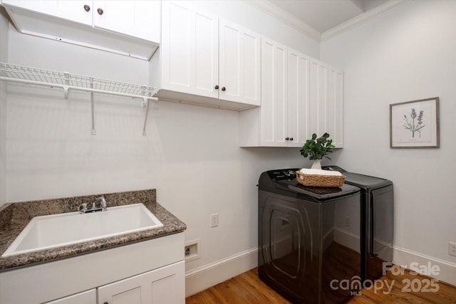 3408 Sandalwood Ln, Waxhaw, NC 28173 - laundry area featuring cabinet space, light wood-type flooring, crown molding, and washing machine and dryer