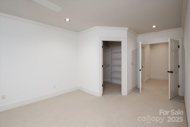 3408 Sandalwood Ln, Waxhaw, NC 28173 - unfurnished bedroom with light carpet, recessed lighting, crown molding, a spacious closet, and a closet