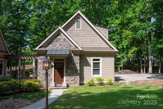 3408 Sandalwood Ln, Waxhaw, NC 28173 - craftsman house with stone siding, a front yard, a standing seam roof, and a metal roof
