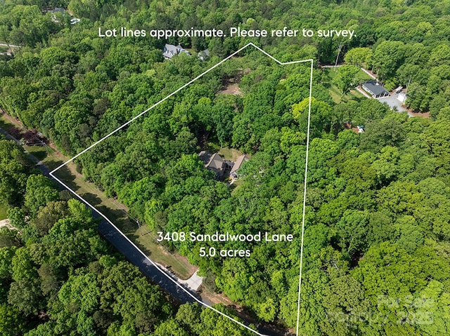 3408 Sandalwood Ln, Waxhaw, NC 28173 - aerial view of property's location featuring a heavily wooded area and property boundaries highlighted