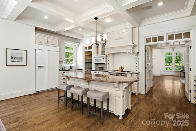 3408 Sandalwood Ln, Waxhaw, NC 28173 - kitchen featuring paneled built in refrigerator, white microwave, coffered ceiling, a center island, and plenty of natural light