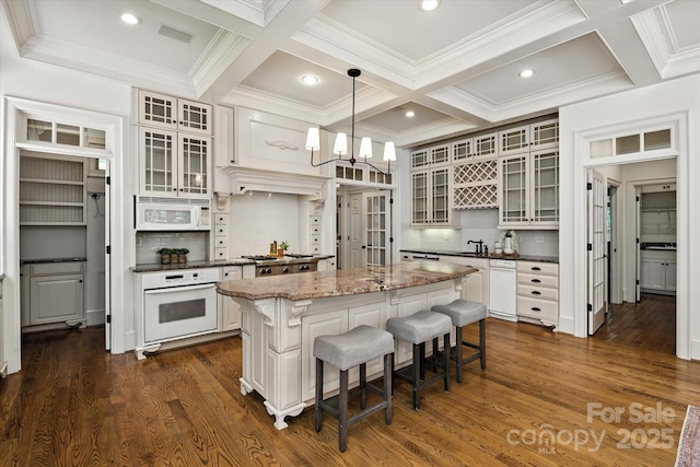 3408 Sandalwood Ln, Waxhaw, NC 28173 - kitchen with white appliances, coffered ceiling, a kitchen island, a breakfast bar area, and decorative backsplash