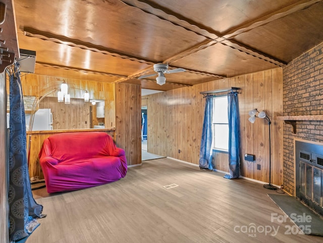70 John Delk Rd, Hendersonville, NC 28792 - living area featuring wooden walls, wood finished floors, a brick fireplace, a ceiling fan, and wooden ceiling