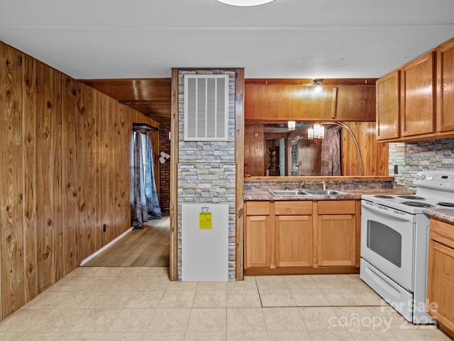 70 John Delk Rd, Hendersonville, NC 28792 - kitchen with white electric range, wood walls, tasteful backsplash, and brown cabinets