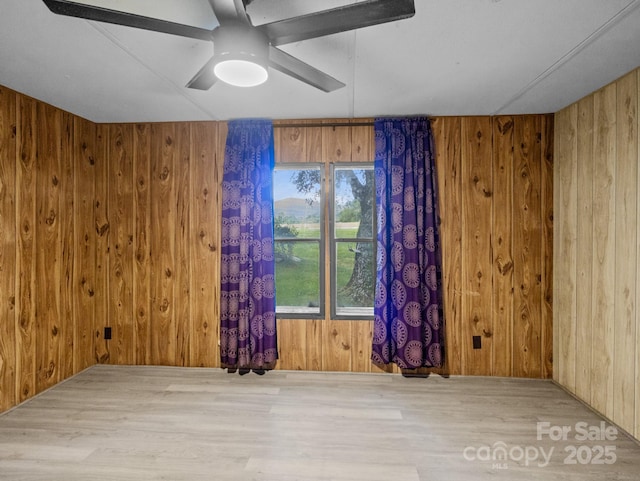70 John Delk Rd, Hendersonville, NC 28792 - spare room featuring wood walls, wood finished floors, and ceiling fan