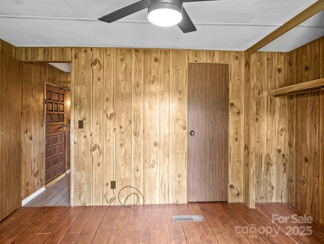 70 John Delk Rd, Hendersonville, NC 28792 - spare room featuring wooden walls, wood-type flooring, and a ceiling fan
