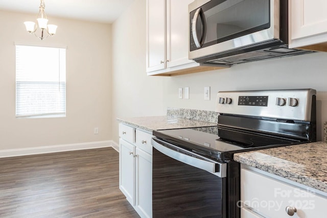 116 Kennford Trl, Troutman, NC 28166 - kitchen with appliances with stainless steel finishes, dark wood-type flooring, white cabinetry, and a chandelier