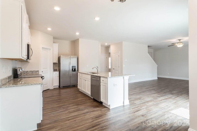 116 Kennford Trl, Troutman, NC 28166 - kitchen featuring stainless steel appliances, ceiling fan, dark wood-type flooring, white cabinetry, and an island with sink