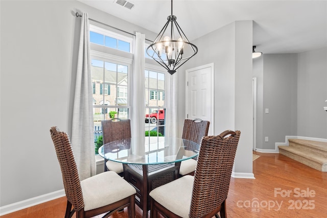 4103 Christine Ln Unit E, Waxhaw, NC 28173 - dining space featuring a chandelier, stairway, and light wood-style floors