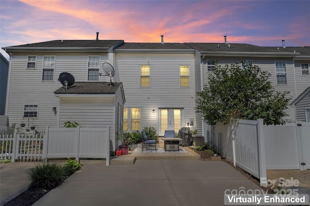 4103 Christine Ln Unit E, Waxhaw, NC 28173 - back of house at dusk featuring a patio area
