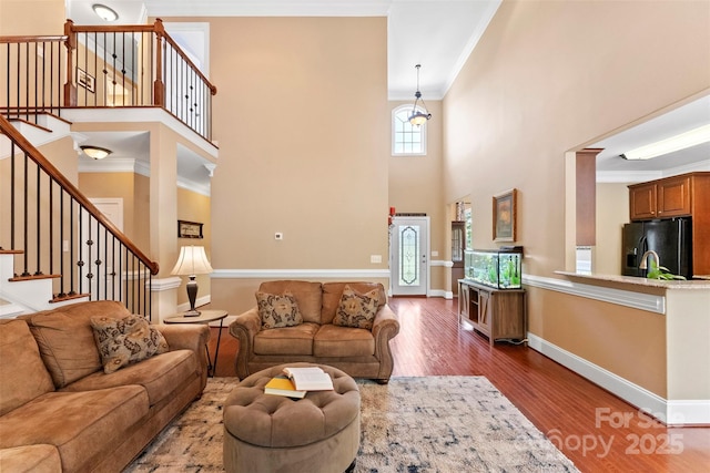 2074 Brandt Rd, York, SC 29745 - living area with crown molding, wood finished floors, a towering ceiling, and stairs