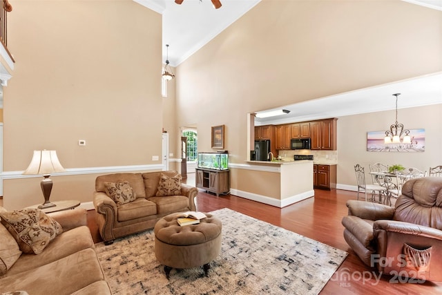 2074 Brandt Rd, York, SC 29745 - living area featuring high vaulted ceiling, dark wood-style floors, a chandelier, a ceiling fan, and crown molding