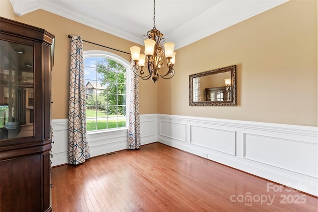 2074 Brandt Rd, York, SC 29745 - spare room featuring healthy amount of natural light, a chandelier, hardwood / wood-style flooring, crown molding, and a wainscoted wall