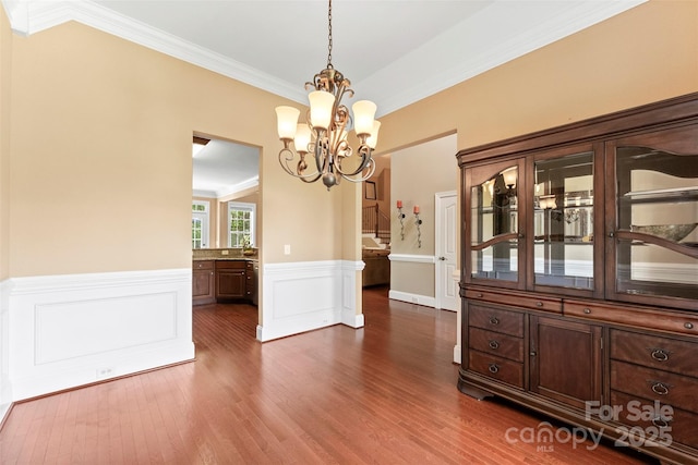 2074 Brandt Rd, York, SC 29745 - unfurnished dining area featuring a chandelier, dark wood-type flooring, a wainscoted wall, and crown molding