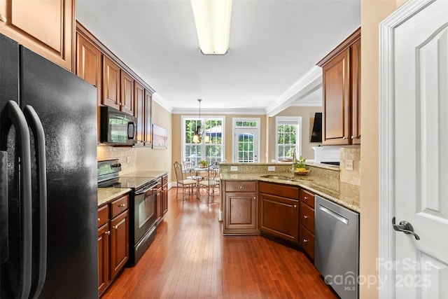 2074 Brandt Rd, York, SC 29745 - kitchen featuring black appliances, dark wood finished floors, decorative backsplash, a peninsula, and brown cabinetry