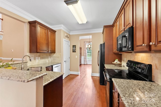 2074 Brandt Rd, York, SC 29745 - kitchen with black appliances, light stone counters, light wood-style flooring, tasteful backsplash, and a peninsula