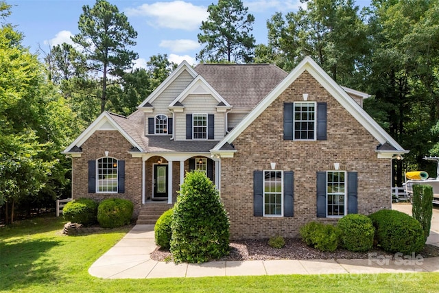2074 Brandt Rd, York, SC 29745 - view of front of home featuring a front lawn, a shingled roof, and brick siding