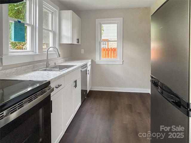 33 Graybark Ct, Waynesville, NC 28786 - kitchen featuring appliances with stainless steel finishes, dark wood-style flooring, light countertops, and white cabinets