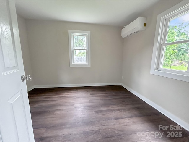 33 Graybark Ct, Waynesville, NC 28786 - spare room with a wall mounted air conditioner, healthy amount of natural light, and wood finished floors